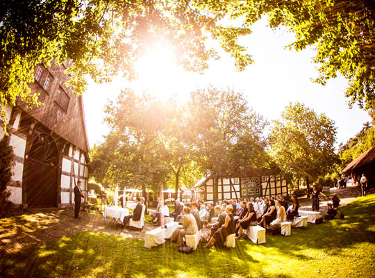 Ein ausgesprochen schöner Hof mit grüner Wiese und gemütlichen Tischgarnituren, optimal für ein unvergessliches Dinnerkrimi Open-Air