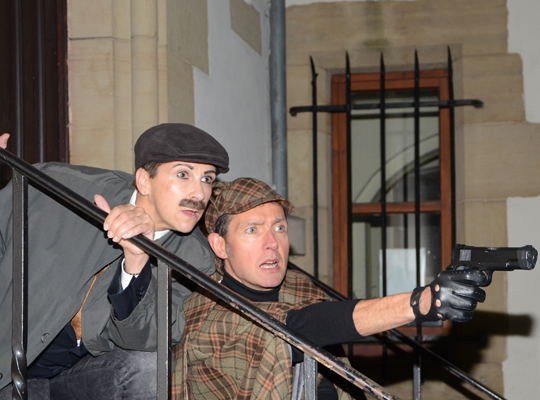 Sherlock Holmes mit einer Pistole in der Hand und sein Kollege Dr. Watson beim schwäbischen Krimidinner